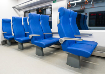 Blue armchairs in the modern speed train