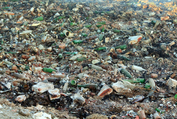 Large garbage dump waste with broken bottles
