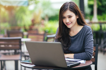 Asian business woman working in in coffee shop cafe with laptop paper work (Business woman concept.)