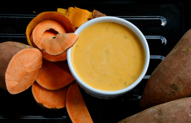 Salad cream made from sweet potato steamed and raw potatoes on black tray.
Homemade Sweet Potatoes Menu eating with fresh vegetable for healthy.