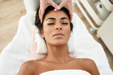 Fototapeta na wymiar Woman receiving head massage in spa wellness center.