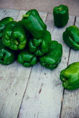 Green peppers on table.