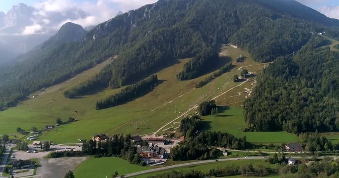 Alpine town, C4K aerial sideway, drone shot of Kranjska Gora village and Trigolov national park, on a sunny summer day, in the Julian alps, Slovenia