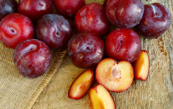 Plum Benefits Your Digestion & Cardiovascular Health.
Many Plums(German name is Pflaumen dunkel )on wooden background.