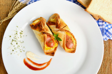 Toast bread Menu.
Toasted Hot Dogs and Cheese on white dish and wheat with fresh toast on wooden background.