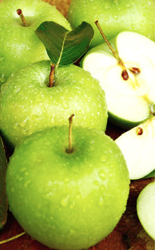 Health Benefits Of Granny Smith Apples.
Green apples with leaf and water drop on wooden background.