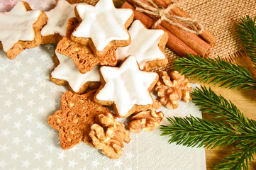 cinnamon star cookies (German name is Zimtsterne) with Christmas tree and hazelnuts.