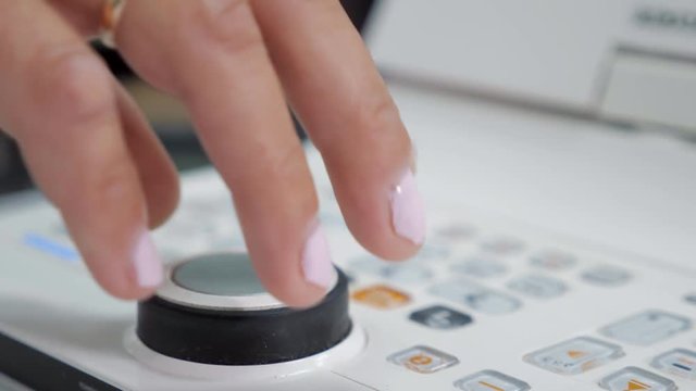 Close up hands of woman doctor working with the refractometer machine.