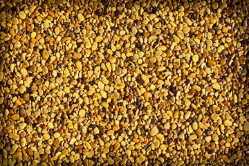 Small yellow stones on the road surface as background