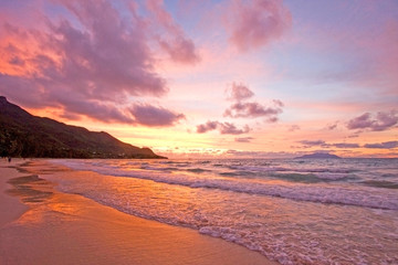 Sunset over a beautiful beach in Mahe, Seychelles.