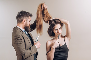 Hairdresser make fashion hairstail. Very Long hair on black background with copy space. Beautiful model with very long hair. Hairdresser, beauty salon.