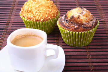 Chocolate chips muffins with coffee on wooden background