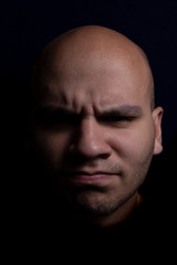 Portrait of Bald Man on Black Background