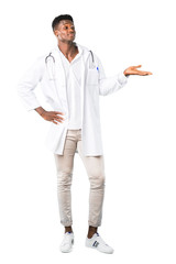 Full body of African american doctor holding copyspace imaginary on the palm to insert an ad on white background