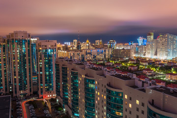 New modern residential complex. View from the apartment to the yard. Night city. Astana, Kazakhstan.