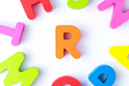 R letters in English made from wood bright colors.