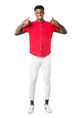 Full body of Young african american man giving a thumbs up gesture and smiling because has had success on white background