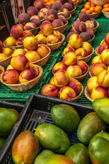 Fresh mangoes and nectarines on display at a farmers' market in Oxford in England