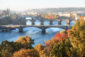 Obraz premium Central Prague and six bridges on Vltava river in Prague on a misty morning in Autumn