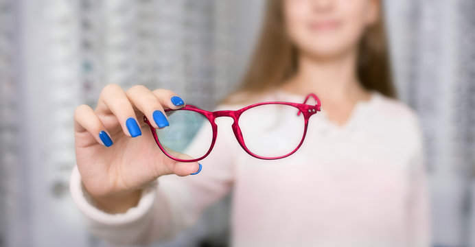 pink frame for glasses, selective focus. Choose in-store trendy glasses for vision correction.
