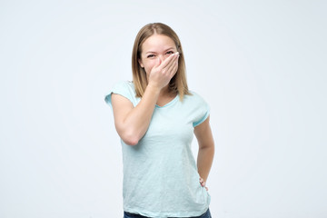 Young woman feels shy, receiving compliments from her friends or teacher.