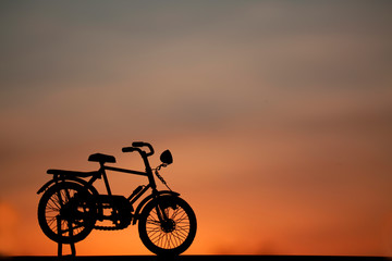 Fototapeta na wymiar bicycle silhouette on sweet sky and shadow