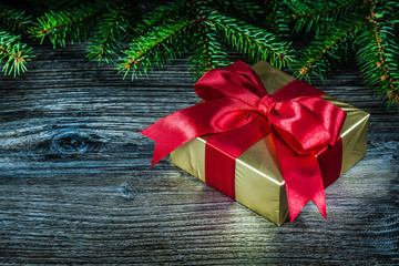 Gift box pine tree branch on vintage wooden board