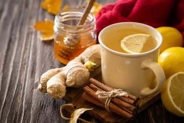 Fototapete Tee Autumn hot drink - ginger, lemon, honey tea and ingredients, wood back