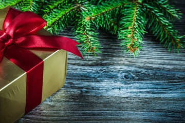 Present box evergreen branch on wooden board