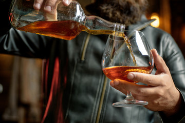 Whisky, brandy or cognac in glass. Alcohol addiction. Addictive group including alcohol cigarettes and drugs. Hard drugs and alcohol addict. Serious sad woman having alcohol addiction.