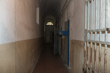 Long Corridor and White and Worn Walls of a Prison