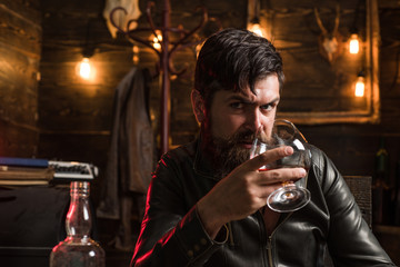 Bearded man drinking alcohol. Whisky, brandy or cognac concept. Serious sad man having alcohol addiction. Alcohol addiction concept.