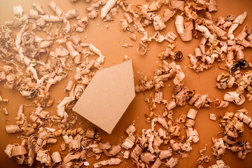 house design concept with house paper model with wood saw dust background
