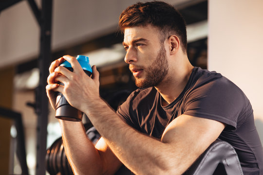Handsome man resting during a workout at the gym