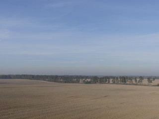 View of the empty plowed fields. Plowed field from a height of flight.