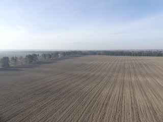View of the empty plowed fields. Plowed field from a height of flight.