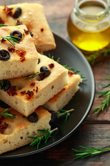 Homemade Italian focaccia with sun dried tomatoes, black olives and rosemary