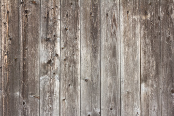 wooden background, old village fence with slits and nails