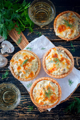 Tartlets with mushrooms, chicken and cheese, top view, selective focus