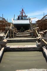 Wooden ships under construction on a beach in Ecuador.