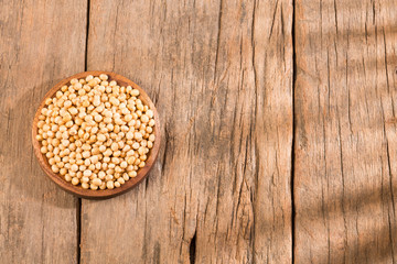 Dry soybeans - Glycine max. Wooden background