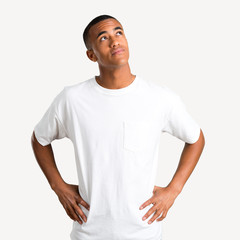Young african american man stand and looking up on isolated background