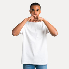 Young african american man showing a sign of closing mouth and silence gesture on isolated...