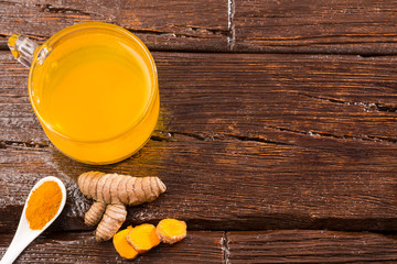 Turmeric and water, healthy drink - Wooden background