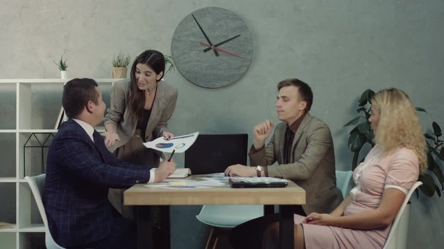 Anxious female team leader scolding her colleagues for bad results and lack of enthusiasm during meeting in boardroom. Tired overworked manager falling asleep during business team meeting at office.