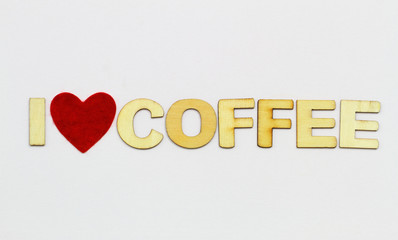 I love coffee written with wooden letters on white surface and red heart

