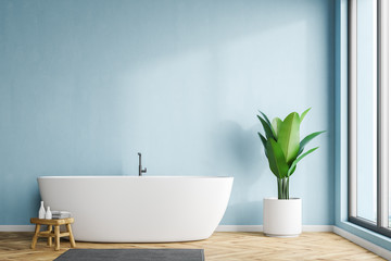Fototapeta na wymiar White tub in blue bathroom interior