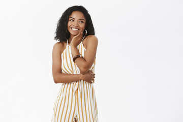 Portrait of charming elegant dark-skinned female enjoying awesome party wearing cute yellow striped...