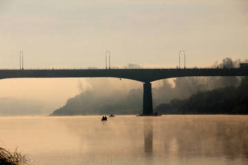 Big modern bridge at sunrise in fog
