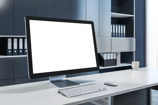 Mock up computer screen in gray office interior